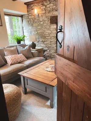 a living room with a couch and a table at Boutique country hideaway ‘Jacks Cottage’ in Diddlebury