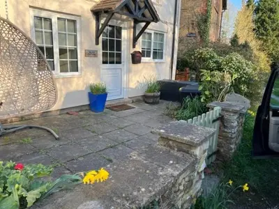 a house with a stone walkway leading to a front door at Boutique country hideaway ‘Jacks Cottage’ in Diddlebury