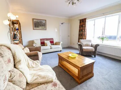 a living room with couches and a coffee table at Maesbury Manor in Oswestry