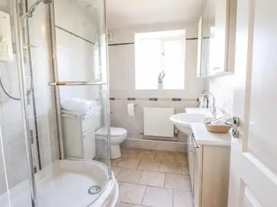 a bathroom with a shower and a toilet and a sink at Maesbury Manor in Oswestry