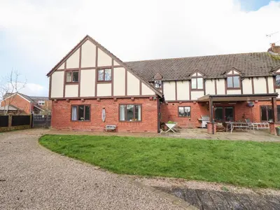 a large house with a yard in front of it at Maesbury Manor in Oswestry