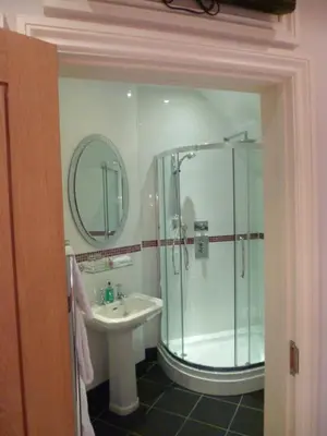 a bathroom with a shower and a sink at Castle Hotel in Aberystwyth