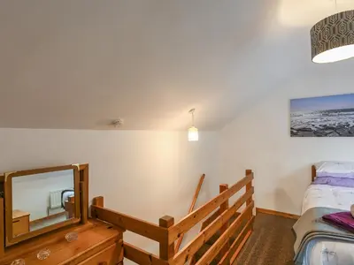 a bedroom with a mirror and a bed at Maldwyn in Tywyn