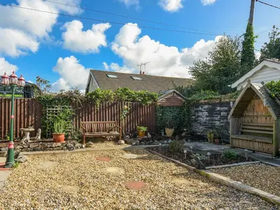a backyard with a fence and a bench at Maldwyn in Tywyn