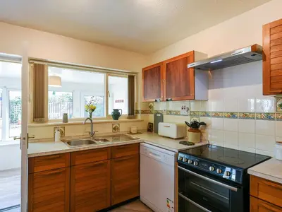 a kitchen with a sink and a stove at Maldwyn in Tywyn