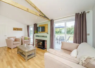 a living room with a couch and a fireplace at Winston Farm Lodges in Ternhill