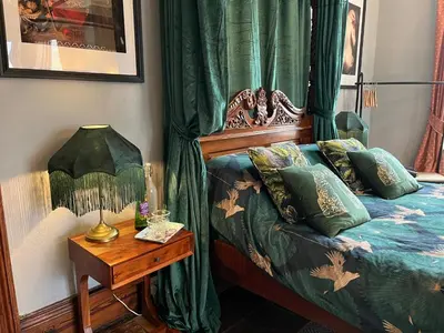 a bedroom with a bed and a table with a lamp at Cader en suite at Pen Y Coed Hall exclusive Luxury Hot Tub in Dolgellau