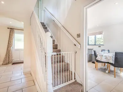 a staircase in a home with a table and a dining room at Hill View Lodge in Knucklas