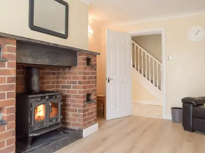 a brick fireplace in a living room with a fire place at Hill View Lodge in Knucklas