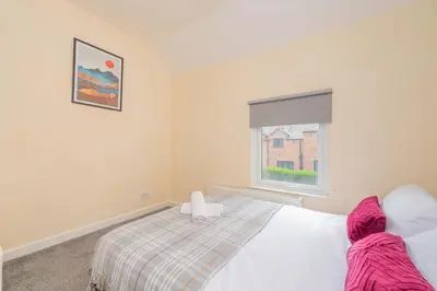 a bedroom with a bed and a window at Coton Hill Shrewsbury Cottage in Shrewsbury