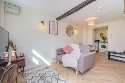 a living room with a couch and a table at Coton Hill Shrewsbury Cottage in Shrewsbury