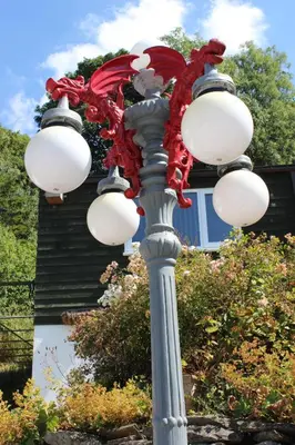 a street light with a dragon on top of it at Poplar Lodge, Dee Valley Stays - cosy microlodge with detached private shower & WC in Corwen