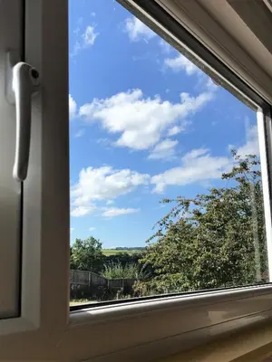 a window with a view of a blue sky at Poplar Lodge, Dee Valley Stays - cosy microlodge with detached private shower & WC in Corwen
