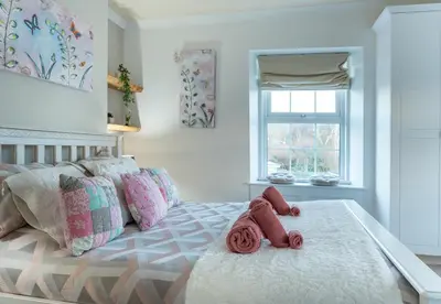 a bedroom with a bed with two teddy bears on it at YR HEN FICERDY in Aberystwyth