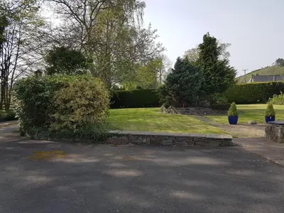 a garden with a park with bushes and trees at YR HEN FICERDY in Aberystwyth