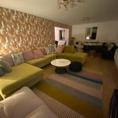 a living room with a couch and a table at Luxury 4-5 Bed Home with Games Room and Balcony in Newtown