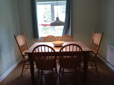 a dining room table with chairs and a bowl on it at Avryn - Delightful 3 bedroom cottage with stunning vistas in Mainstone