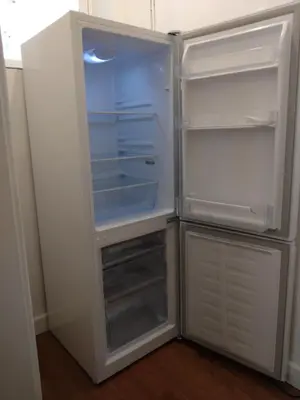 an empty refrigerator with its door open in a kitchen at Avryn - Delightful 3 bedroom cottage with stunning vistas in Mainstone