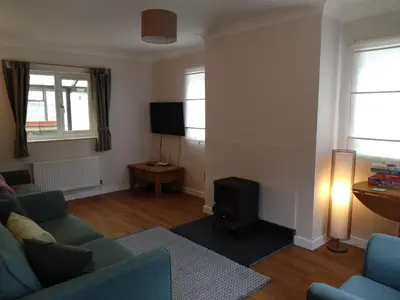 a living room with a couch and a television at Avryn - Delightful 3 bedroom cottage with stunning vistas in Mainstone