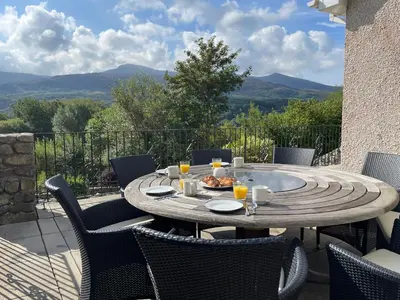 a table with a plate of food on a patio at Lleifior in Dolgellau
