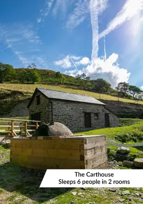 a stone barn with a sign that reads the carthage sleeps people in at Cwm Clyd - Carthouse in Rhayader