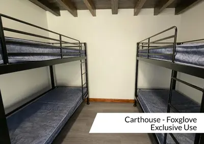 a room with three bunk beds in a room at Cwm Clyd - Carthouse in Rhayader