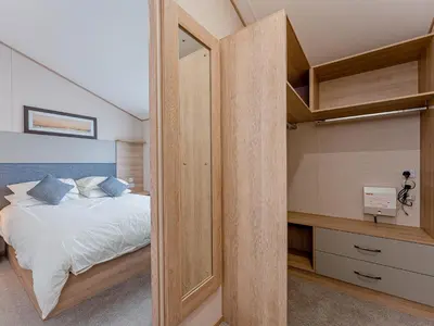 a bedroom with a bed and a walk in closet at Cledan in Aberaeron