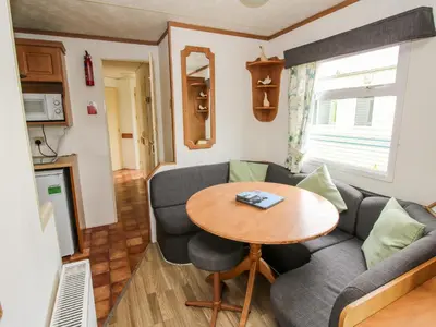 a living room with a couch and a table at 6 Old Orchard in Much Wenlock