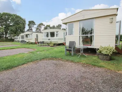 a house with a table and chairs in a yard at 10 Old Orchard in Much Wenlock
