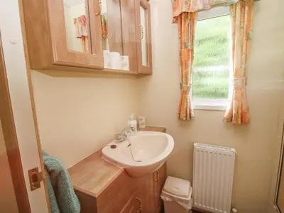 a small bathroom with a sink and a window at 10 Old Orchard in Much Wenlock