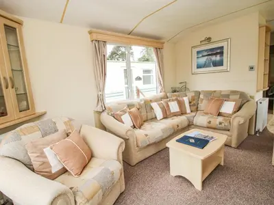 a living room with two couches and a table at 4 Old Orchard in Much Wenlock