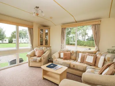 a living room with two couches and a table at 4 Old Orchard in Much Wenlock