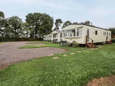 a row of mobile homes parked in a yard at 3 Old Orchard in Much Wenlock