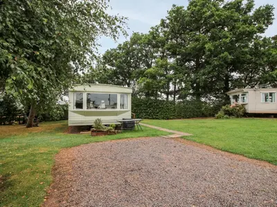 a caravan sitting on the grass in a yard at 9 Old Orchard in Much Wenlock