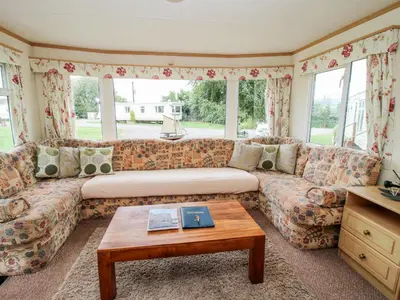 a living room with a couch and a coffee table at 9 Old Orchard in Much Wenlock