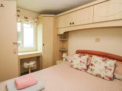 a small bedroom with a bed and a window at 5 Old Orchard in Much Wenlock
