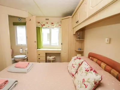 a small bedroom with a bed and a bathroom at 5 Old Orchard in Much Wenlock