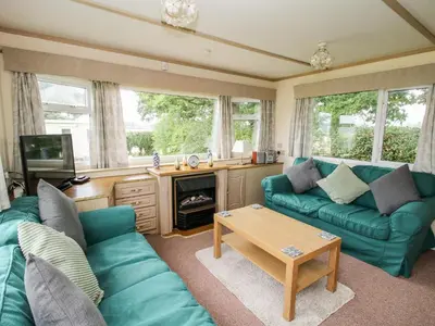 a living room with a couch and a table at 7 Old Orchard in Much Wenlock