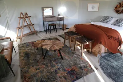 a bedroom with a bed and a table and a desk at Heart of the Wye in Clifford