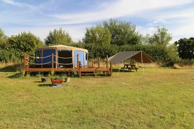 a yurt and a tent in a field at Heart of the Wye in Clifford