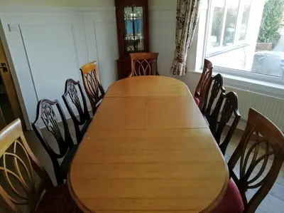 a wooden table and chairs in a room at Country Home with Gardens in Newtown
