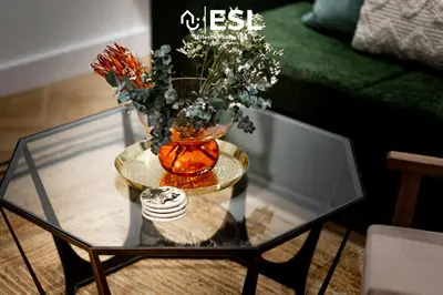 a glass coffee table with a vase with flowers on it at Contemporary Townhouse - Free Parking - Central Shrewsbury in Shrewsbury