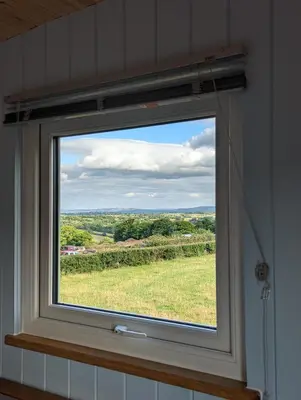 a window with a view of a field of grass at Red darren luxury hut in Llanveynoe
