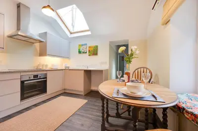 a kitchen and dining room with a table and chairs at 2 Bed in Barmouth oc-wag721 in Barmouth