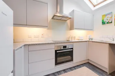 a kitchen with white cabinets and a stove at 2 Bed in Barmouth oc-wag721 in Barmouth