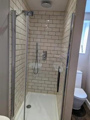 a bathroom with a shower with a toilet at The Cob House. in Ifton Heath