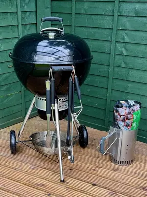 a black barbecue grill sitting on a wooden deck at Baddegai Holiday Cottage in Brecon