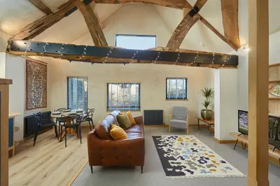 a living room with a couch and a table at Kin Ludlow Rooms in Ludlow