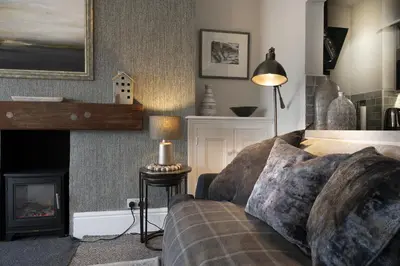 a living room with a couch and a fireplace at Harbour View - Flat 2 - Tudor House in Barmouth