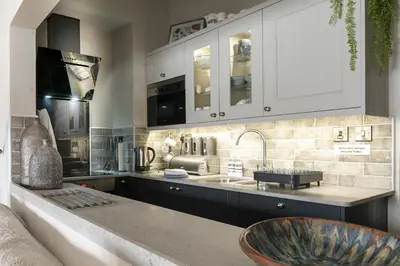 a kitchen with a sink and a counter top at Harbour View - Flat 2 - Tudor House in Barmouth